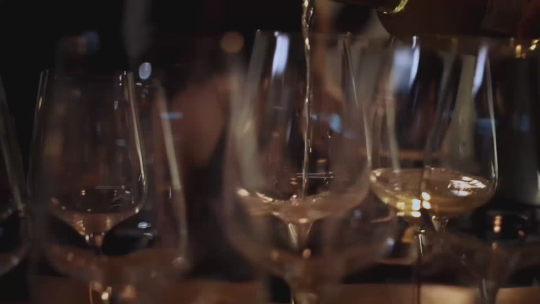 white wine poured into glasses on table with flash camera going off
